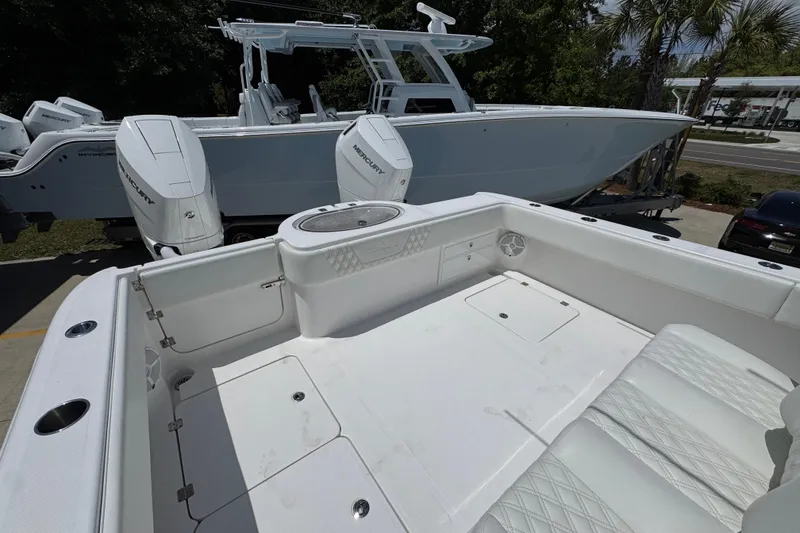 Slide: The Image of 2024 Invincible 33 Catamaran with dual Mercury engines, featuring spacious deck and seating. - 40