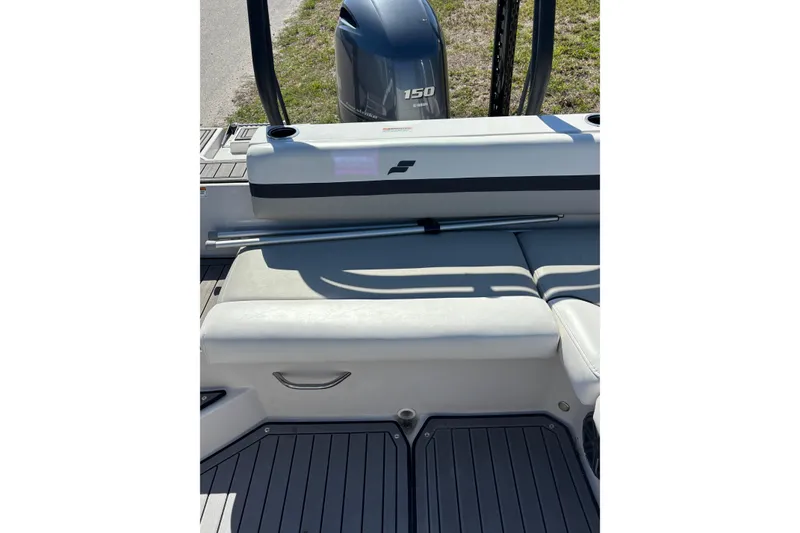 Slide: The Image of 2023 Starcraft SVX 191 OB boat interior with Yamaha 150 engine, featuring cushioned seating. - 10