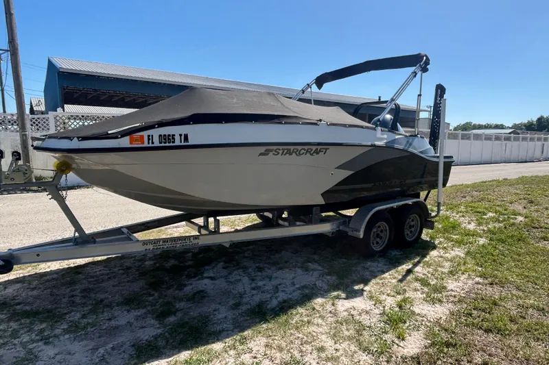 Slide: The Image of 2023 Starcraft SVX 191 OB boat on trailer, covered and parked outdoors. - 14