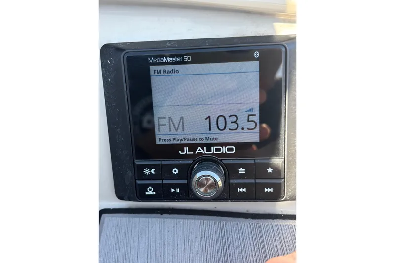 Slide: The Image of JL Audio MediaMaster 50 displaying FM radio at 103.5 frequency on Starcraft SVX 191 OB. - 2