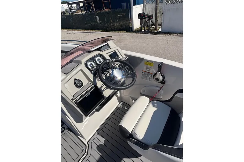 Slide: The Image of 2023 Starcraft SVX 191 OB boat cockpit with steering wheel and control panel. - 6