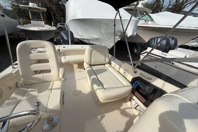 Slide: The Image of 2015 Grady-White Freedom 225 boat interior with seating and steering wheel. - 10