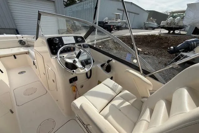 Slide: The Image of 2015 Grady-White Freedom 225 boat interior with steering wheel and seating. - 12
