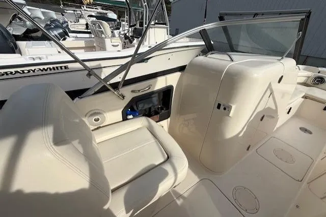 Slide: The Image of 2015 Grady-White Freedom 225 boat interior with seating and dashboard view. - 13