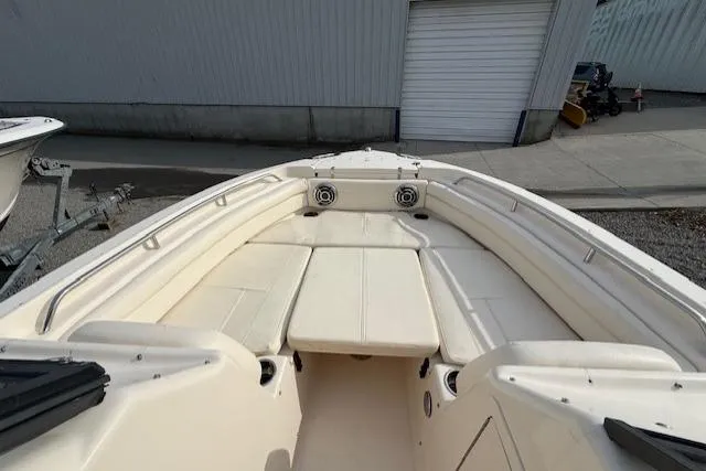 Slide: The Image of 2015 Grady-White Freedom 225 boat interior with cushioned seating and speakers. - 18