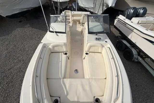 Slide: The Image of 2015 Grady-White Freedom 225 boat interior with seating and windshield, parked on gravel. - 19