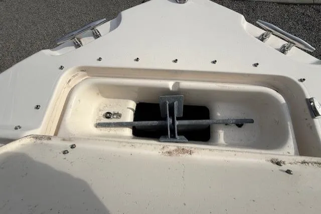 Slide: The Image of Bow anchor compartment of 2015 Grady-White Freedom 225 boat, featuring stainless steel fittings. - 20