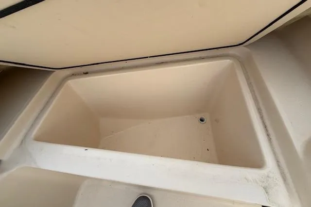 Slide: The Image of Storage compartment of a 2015 Grady-White Freedom 225 boat, open and empty. - 21
