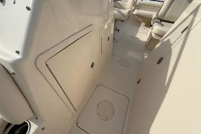 Slide: The Image of 2015 Grady-White Freedom 225 boat interior with seating and storage compartments. - 23