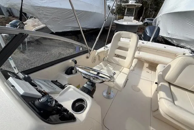 Slide: The Image of 2015 Grady-White Freedom 225 boat interior with steering wheel and seating. - 26