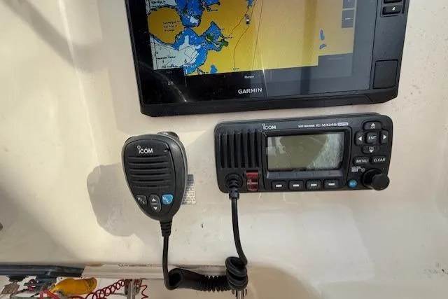 Slide: The Image of Garmin navigation system and Icom radio on 2015 Grady-White Freedom 225 boat. - 30