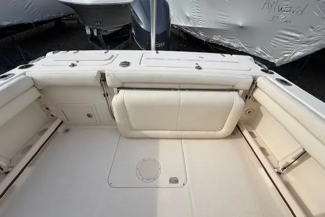 Slide: The Image of 2015 Grady-White Freedom 225 boat interior with white seating and storage compartments. - 38