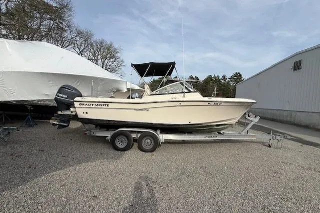 Slide: The Image of 2015 Grady-White Freedom 225 boat on trailer, parked outdoors. - 44