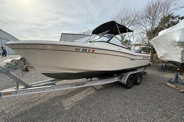Slide: The Image of 2015 Grady-White Freedom 225 boat on trailer, parked outdoors. - 47