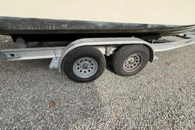 Slide: The Image of Trailer with dual wheels carrying a 2015 Grady-White Freedom 225 boat. - 50