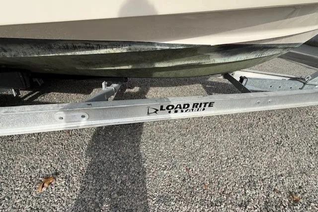 Slide: The Image of 2015 Grady-White Freedom 225 boat on Load Rite trailer, parked on gravel. - 51