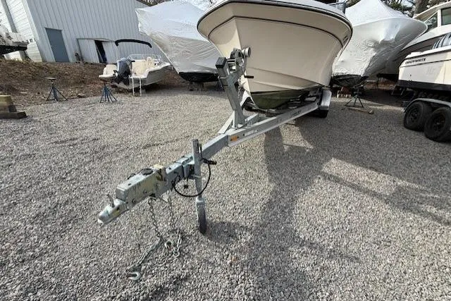 Slide: The Image of 2015 Grady-White Freedom 225 boat on trailer in gravel lot. - 52