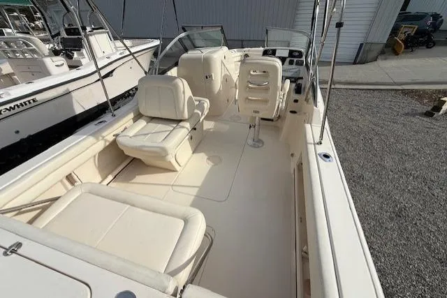 Slide: The Image of 2015 Grady-White Freedom 225 boat interior with seating and steering console. - 7