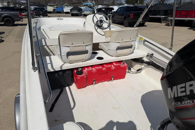 Slide: The Image of 2018 Boston Whaler 150 Super Sport boat interior with seating and red fuel tank. - 4