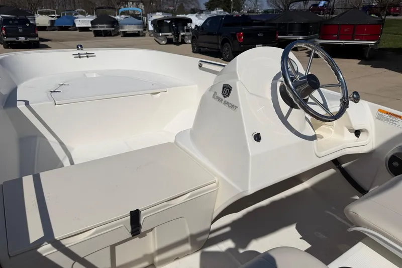 Slide: The Image of 2018 Boston Whaler 150 Super Sport boat interior with steering wheel and seating. - 6