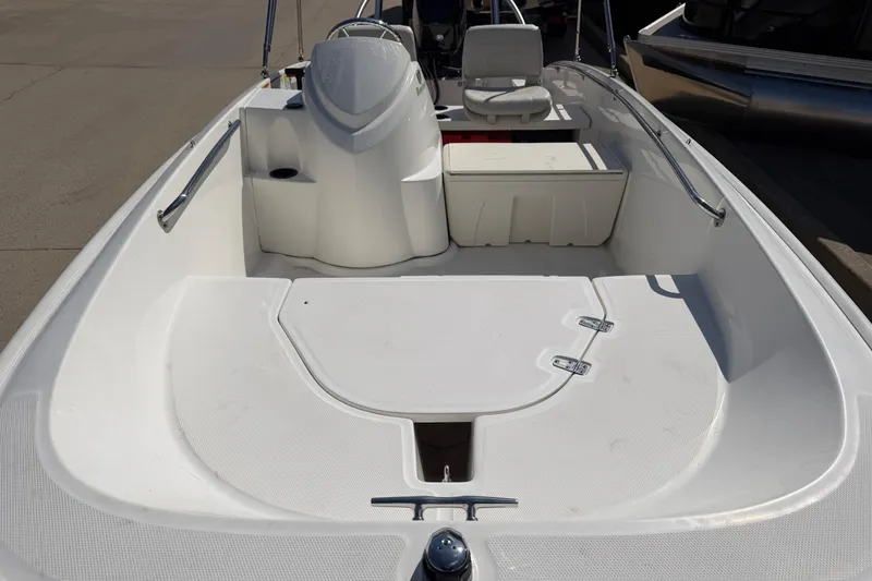 Slide: The Image of 2018 Boston Whaler 150 Super Sport boat interior with seating and storage. - 8