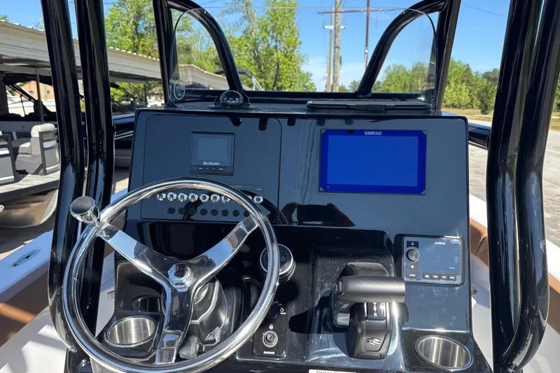 Slide: The Image of 2026 Sea Pro 202 Center Console boat dashboard with steering wheel and navigation displays. - 15