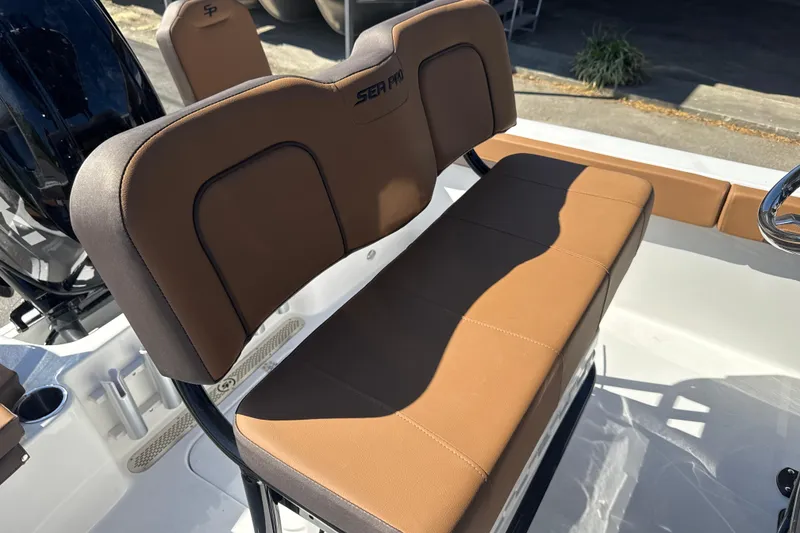 Slide: The Image of 2026 Sea Pro 202 Center Console boat with brown cushioned seating and sleek design. - 16
