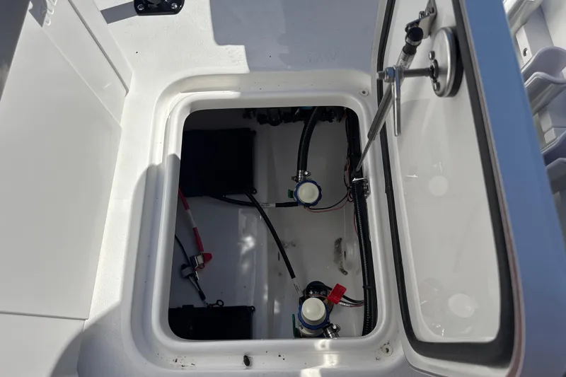 Slide: The Image of Open hatch of 2026 Sea Pro 202 Center Console boat showing internal components. - 21