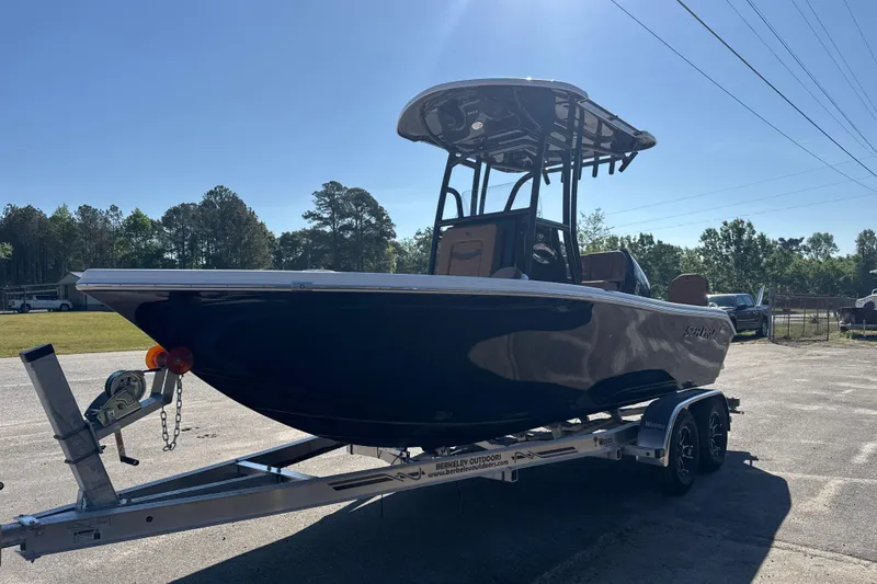 Slide: The Image of 2026 Sea Pro 202 Center Console boat on trailer, parked outdoors under clear sky. - 3