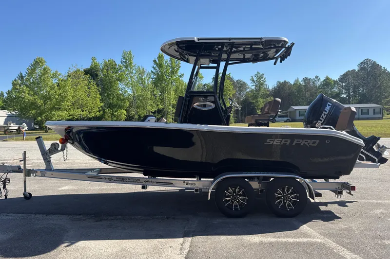 Slide: The Image of 2026 Sea Pro 202 Center Console boat on trailer, parked outdoors. - 4