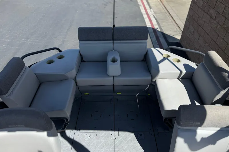 Slide: The Image of 2022 Sea-Doo Switch Sport 21 interior seating with cup holders and gray upholstery. - 15