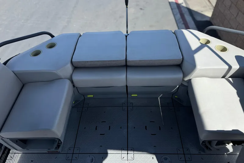 Slide: The Image of 2022 Sea-Doo Switch Sport 21 interior seating with cup holders and cushioned layout. - 16