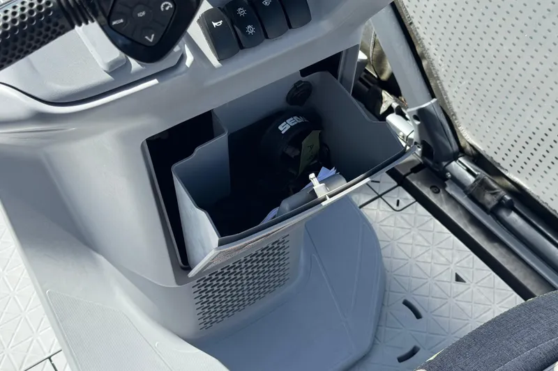 Slide: The Image of 2022 Sea-Doo Switch Sport 21 storage compartment with controls and accessories. - 24