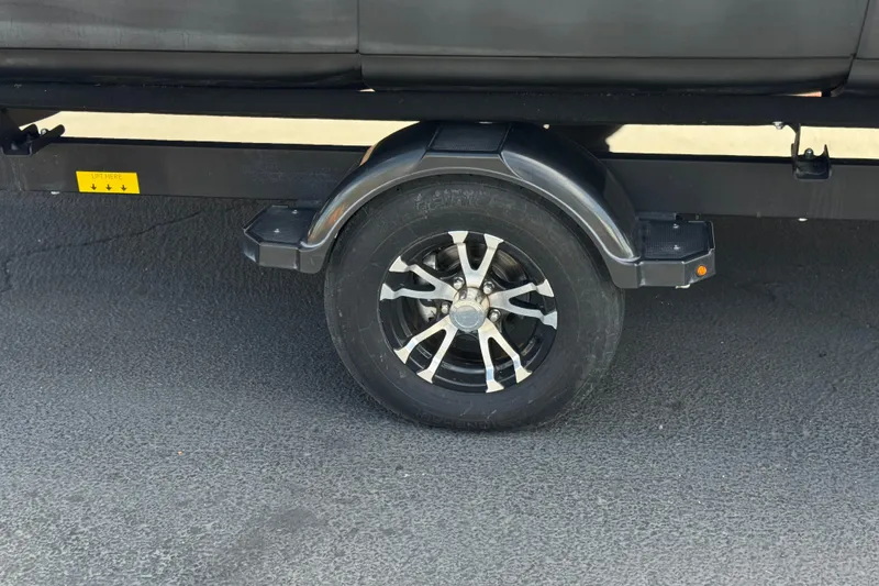 Slide: The Image of Trailer wheel of 2022 Sea-Doo Switch Sport 21 on asphalt surface. - 25