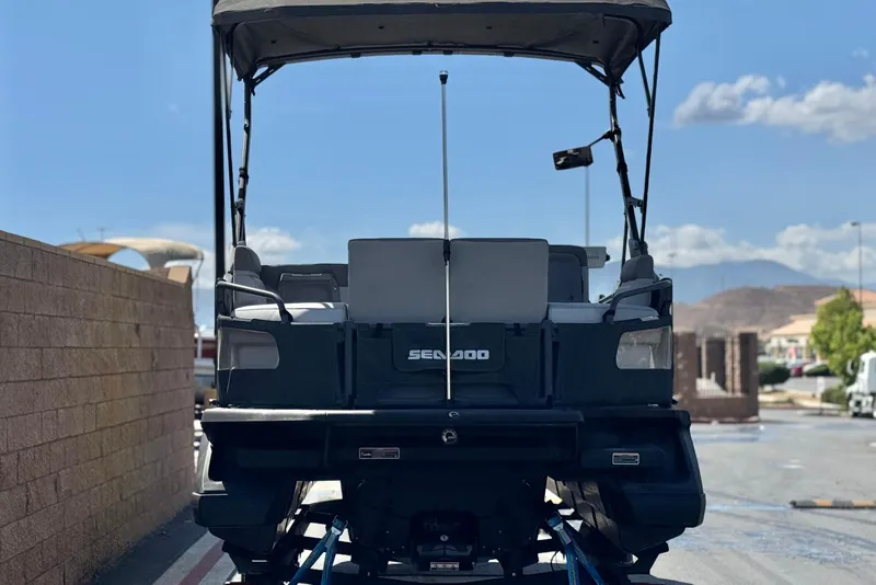 Slide: The Image of 2022 Sea-Doo Switch Sport 21 pontoon boat, rear view, parked outdoors. - 5