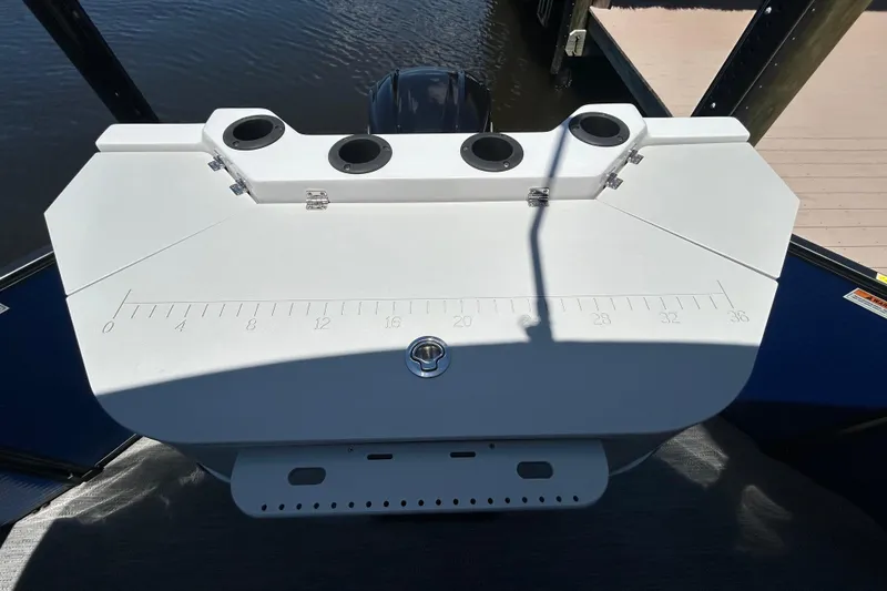 Slide: The Image of Control panel of 2022 Godfrey Sweetwater 2286FS boat with cup holders and measurement markings. - 101