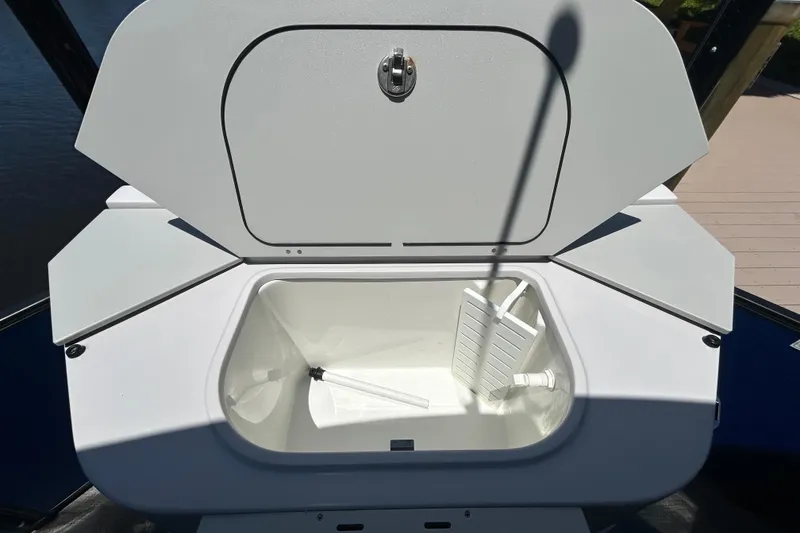 Slide: The Image of Open storage compartment on 2022 Godfrey Sweetwater 2286FS boat, showing interior space. - 102