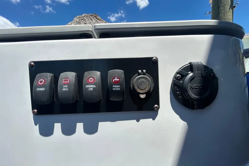 Slide: The Image of Control panel of 2022 Godfrey Sweetwater 2286FS boat with switches and sockets. - 107