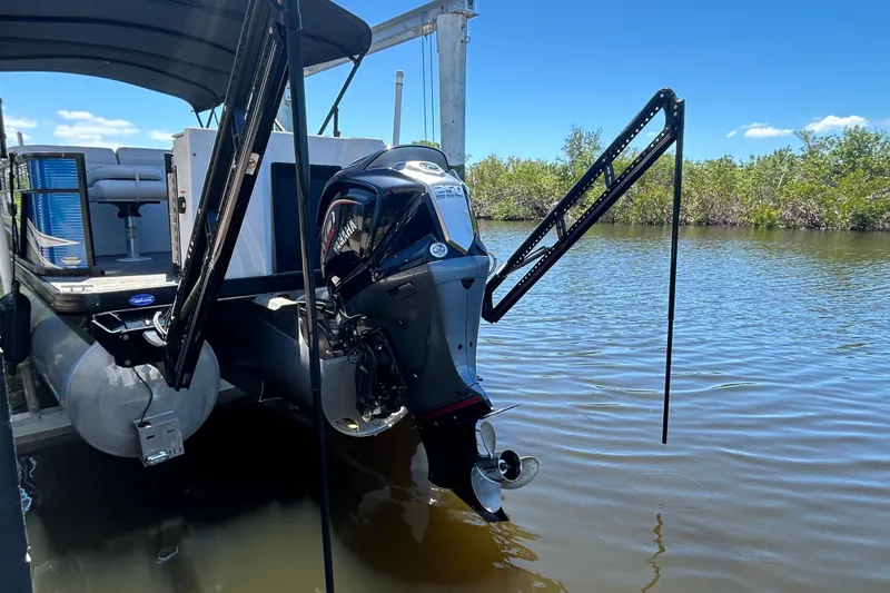 Slide: The Image of 2022 Godfrey Sweetwater 2286FS pontoon boat with Yamaha outboard motor on a calm river. - 11