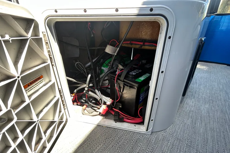 Slide: The Image of Battery compartment of 2022 Godfrey Sweetwater 2286FS pontoon boat, showing wiring and connections. - 111