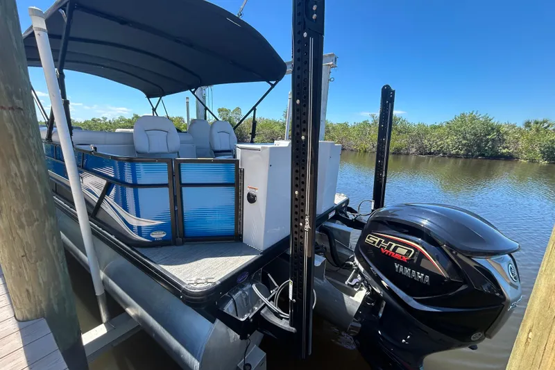 Slide: The Image of 2022 Godfrey Sweetwater 2286FS pontoon boat with Yamaha engine docked by a river. - 12