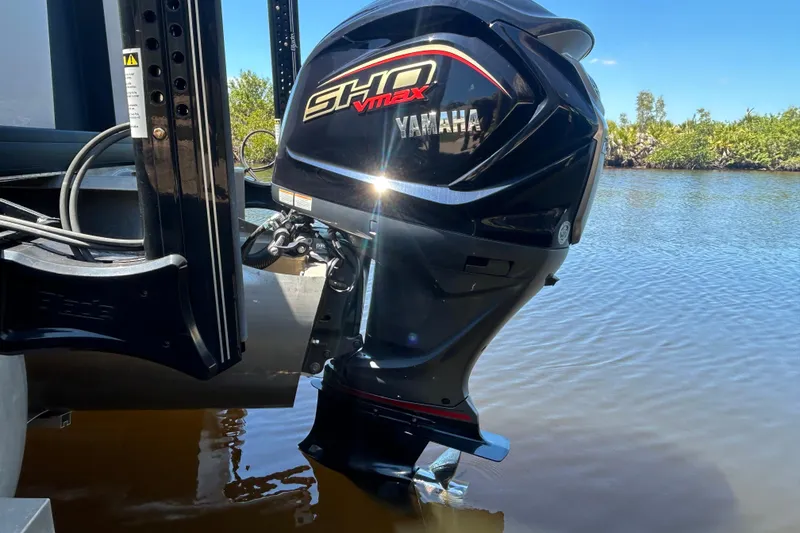 Slide: The Image of Yamaha SHO VMAX outboard motor on 2022 Godfrey Sweetwater 2286FS pontoon boat, near water. - 14
