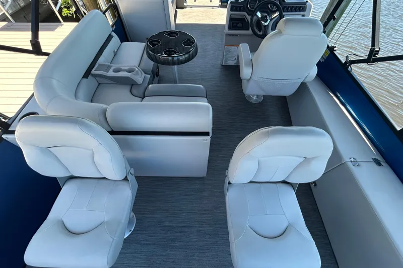 Slide: The Image of Interior of 2022 Godfrey Sweetwater 2286FS boat with white seating and steering console. - 27