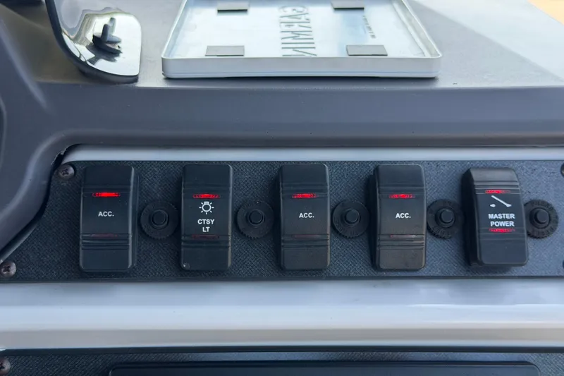 Slide: The Image of Control panel of 2022 Godfrey Sweetwater 2286FS boat with accessory switches. - 31