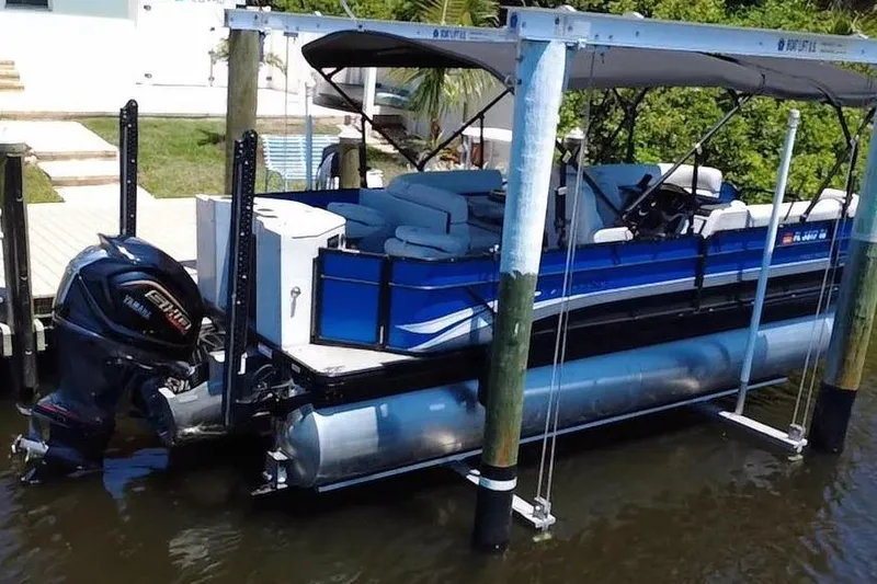 Slide: The Image of 2022 Godfrey Sweetwater 2286FS pontoon boat on lift, featuring Yamaha outboard motor. - 4