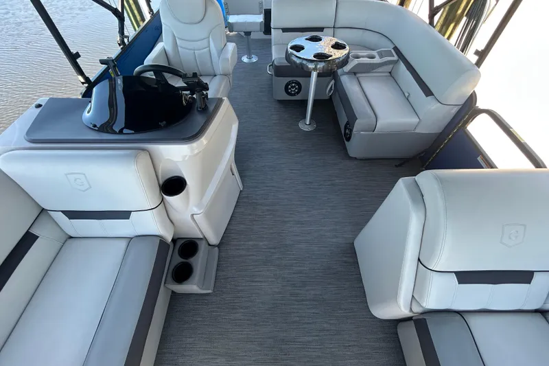 Slide: The Image of Interior of 2022 Godfrey Sweetwater 2286FS pontoon boat with plush seating and helm. - 42