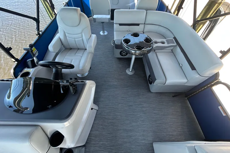 Slide: The Image of 2022 Godfrey Sweetwater 2286FS boat interior with plush seating and steering console. - 44