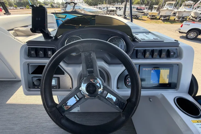 Slide: The Image of Steering console of 2022 Godfrey Sweetwater 2286FS boat with navigation display and controls. - 26