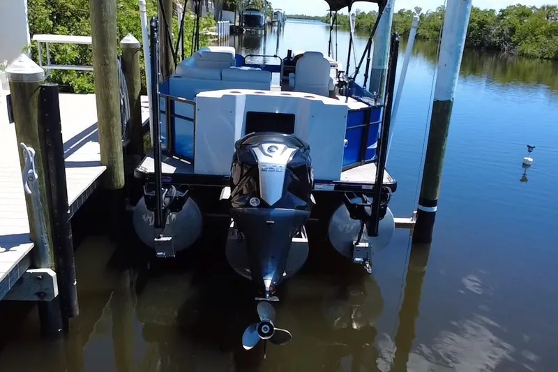 Slide: The Image of 2022 Godfrey Sweetwater 2286FS pontoon boat docked on calm water. - 5
