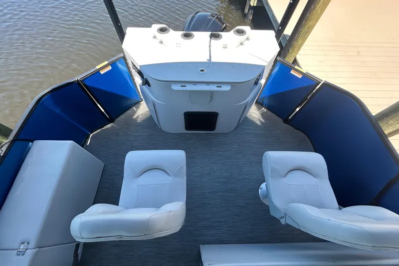 Slide: The Image of 2022 Godfrey Sweetwater 2286FS boat interior with white seating and blue accents. - 50